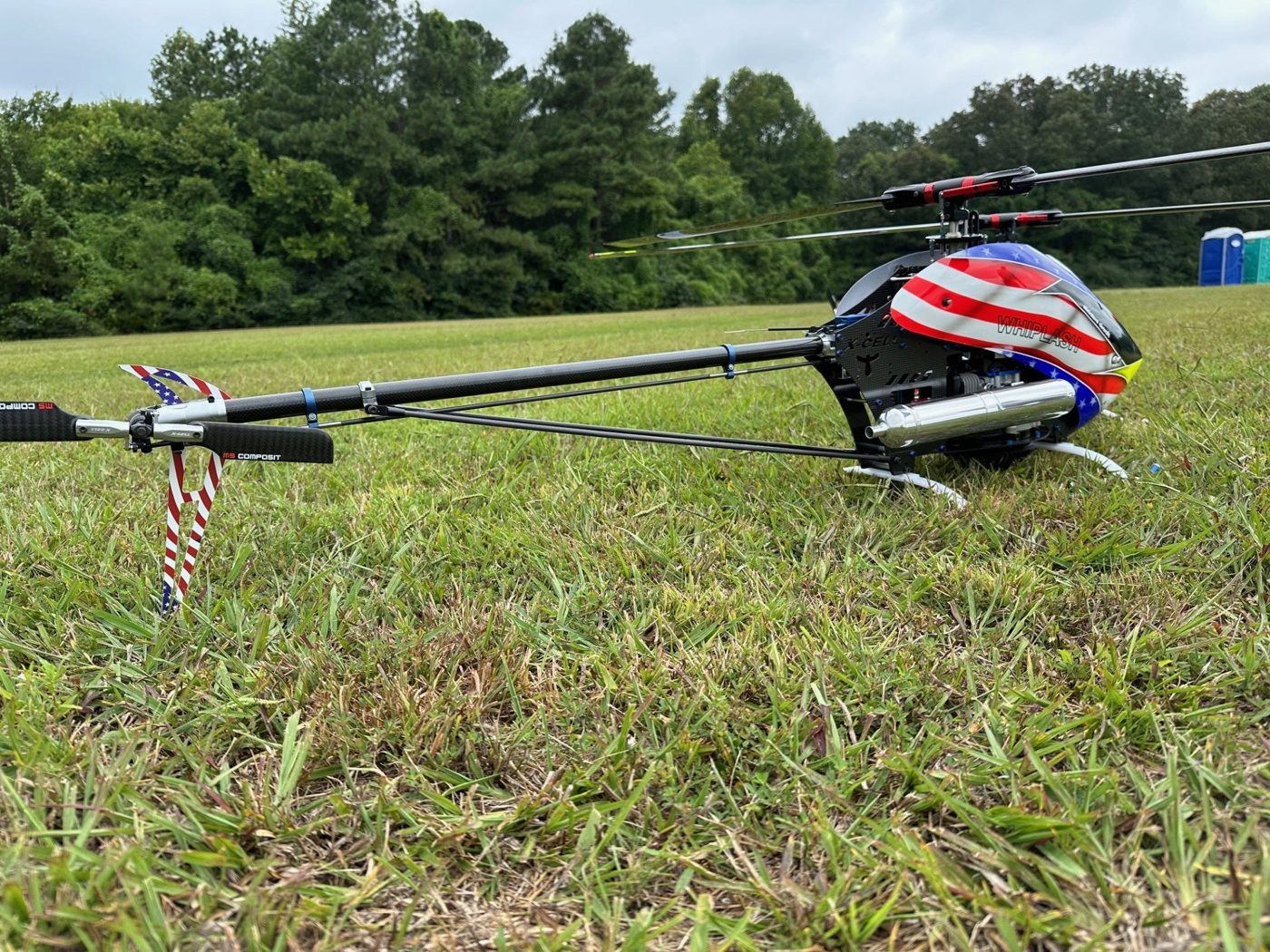 Helicopter with a stars-and-stripes canopy at the flying field